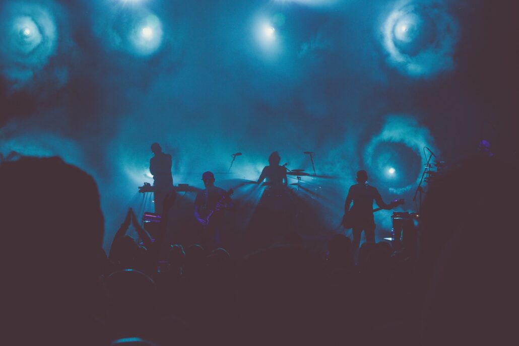 Music band performs on stage during nighttime