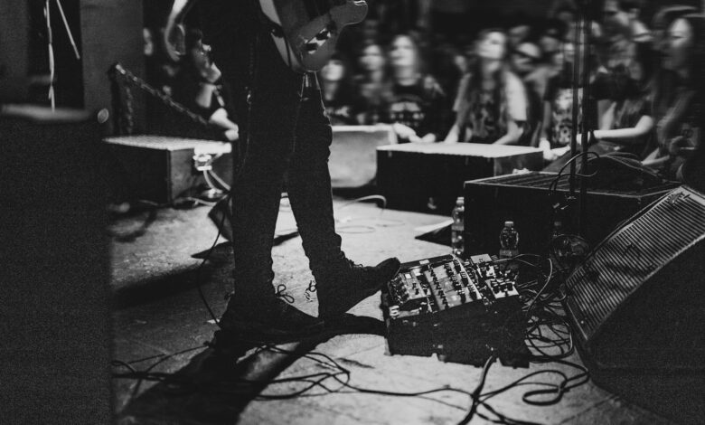 musician using a pedal board in a concert 2022 12 15 23 35 04 utc scaled